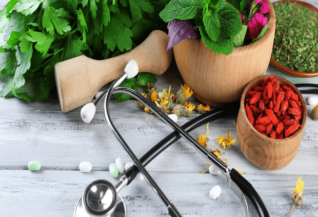 a stethoscope and herbs on a table